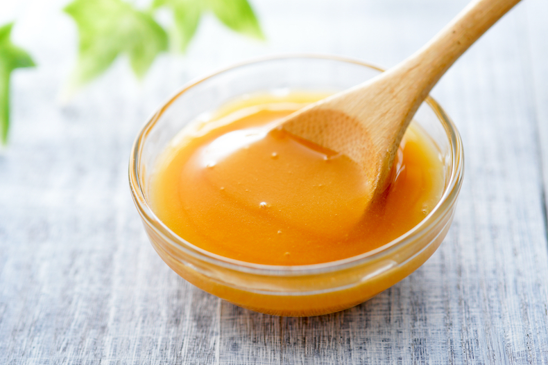 Manuka honey and wooden spoon