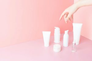 Cosmetic products in the pink wall paper