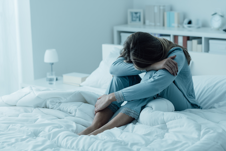 A depressed woman on the bed